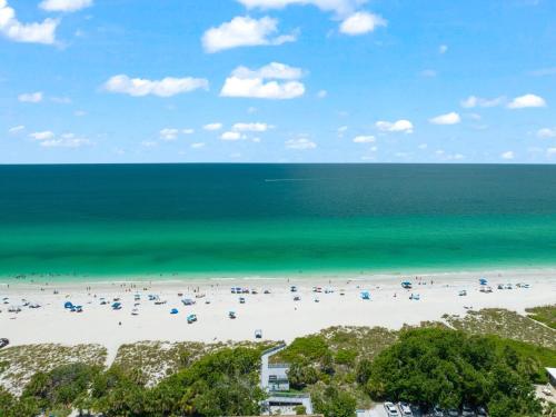 a beach with a large group of people and the ocean at Poco Tortuga in Nokomis