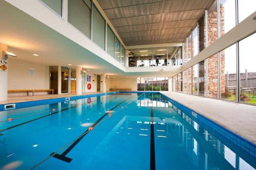 an empty swimming pool in a building at Wyndham Resort Torquay in Torquay