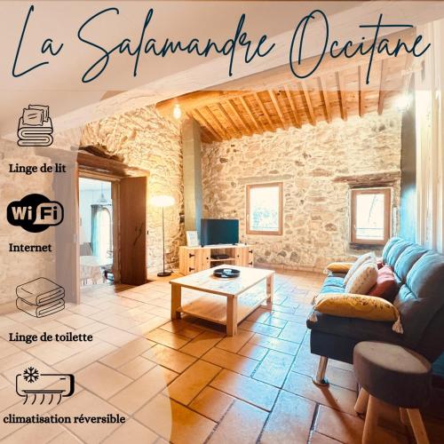 a living room with a couch and a table at 5min baignade en rivière animaux accepté toit terrasse in Bize-Minervois