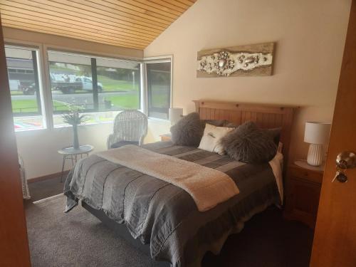 a bedroom with a bed and a window at The Nunnery in Te Aroha