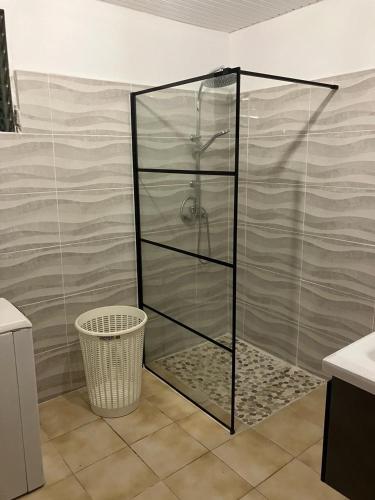 a shower with a glass enclosure in a bathroom at La Maison d 'Hippolyte in Vieux-Habitants