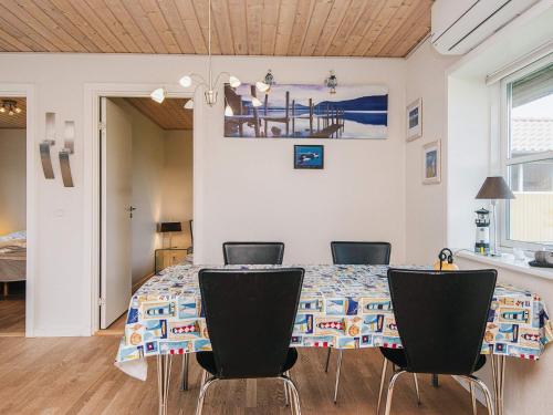 a dining room with a table and chairs at 4 person holiday home in Nørre Nebel in Nørre Nebel
