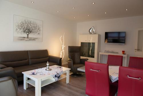 a living room with a couch and a table at Florence in Norden