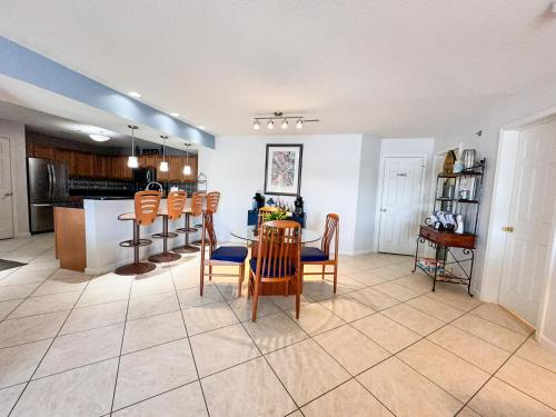 a kitchen and living room with a table and chairs at Lakefront Condo Wdockdeckpools-sleeps 6 in Lake Ozark