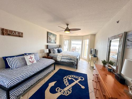 a living room with a couch and a bed at Lakefront Condo Wdockdeckpools-sleeps 6 in Lake Ozark