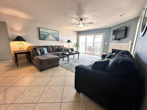 a living room with a couch and a table at Lakefront Condo Wdockdeckpools-sleeps 6 in Lake Ozark