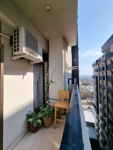 a balcony with a air conditioner on a building at Three Bed Attached Bath Netflix Wifi Smart TV Parking WFH Desk in Islamabad