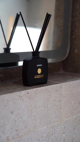 a black object with sticks in it sitting on a counter at Suites El Ghailani in Dakhla