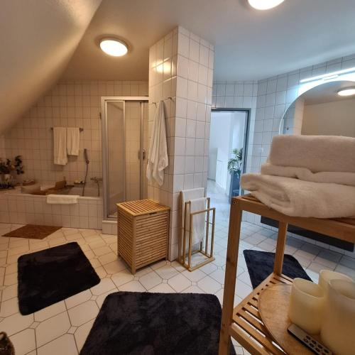 a large bathroom with a shower and a tub at Ferienhaus Roomina in Werlte