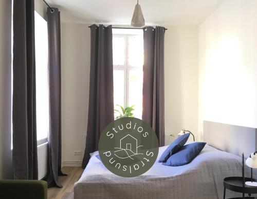 a bedroom with a bed with a sign on it at Studios am Kniepertor in der Altstadt in Stralsund