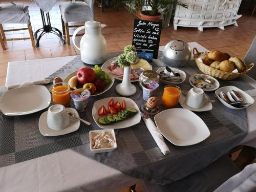 a table with plates of food and fruit on it at Pension Zur Alten Post in Havelberg
