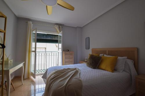 a bedroom with a bed and a desk and a window at Parque 27 in Cartagena