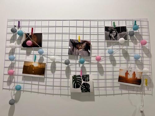 a wall with pictures and ornaments on it at Vinhomes Grand Park Homestay-The Beverly Hills in Long Bình