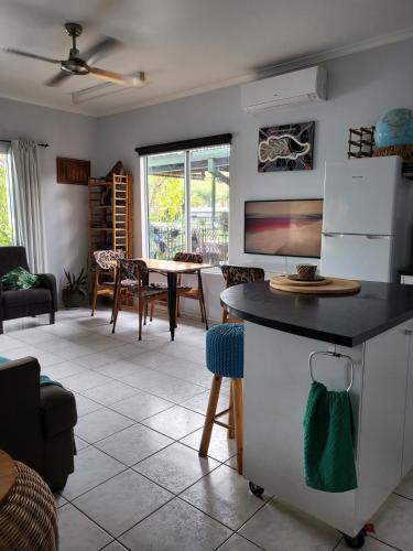 a kitchen and living room with a table and chairs at Barefoot Bungalow 23 Lake Bennett -private pontoon in Lake Bennett