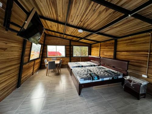 a room with a large bed in a wooden room at la cima de los frailejones in El Hato