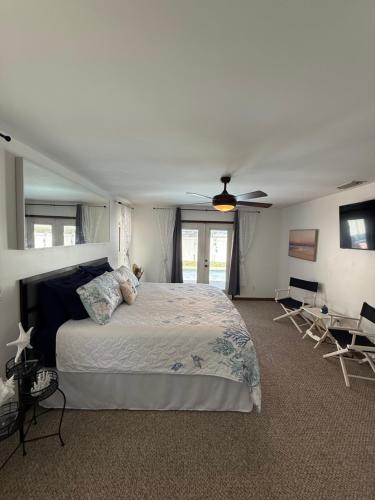 a bedroom with a bed and a ceiling fan at Walk to Waves in Ormond Beach