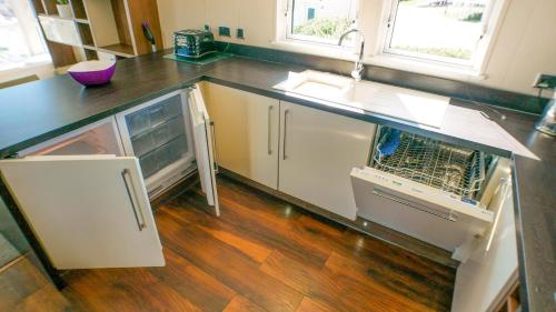 a kitchen with a sink and a counter at 3 Bed 2 Bathroom Super Lodge! Sea Views! in Exmouth