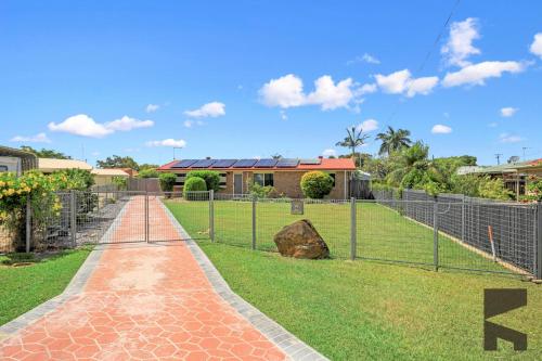 a walkway in front of a house with a fence at 6 McColm Court, Bargara in Bargara