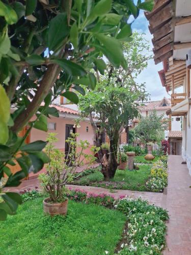 a garden with trees and flowers in a yard at Casona La Recoleta in Cusco