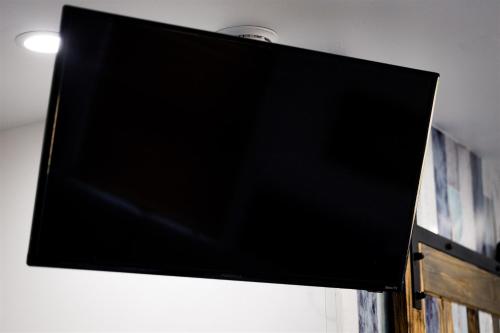 a flat screen tv hanging on a wall at Cape Charles Tiny Livin' in Cape Charles