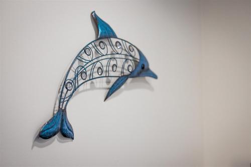 a blue fish hanging on a wall at Cape Charles Tiny Livin' in Cape Charles