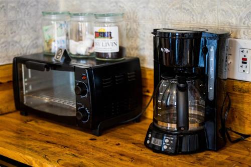a blender sitting next to a microwave on a table at Cape Charles Tiny Livin' in Cape Charles