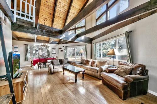 a living room with leather couches and a table at Stay Cool! AC - Foosball - Nature Escape in South Lake Tahoe