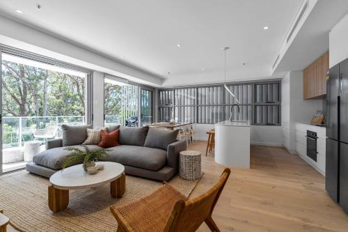 a living room with a couch and a table at Family-Friendly 3BR - Steps from the Beach in Huskisson