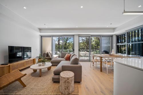 a living room with a couch and a table at Family-Friendly 3BR - Steps from the Beach in Huskisson