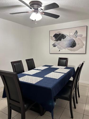 a dining room with a blue table with a ceiling fan at Peaceful Home in Central Florida Near Universal in Orlando