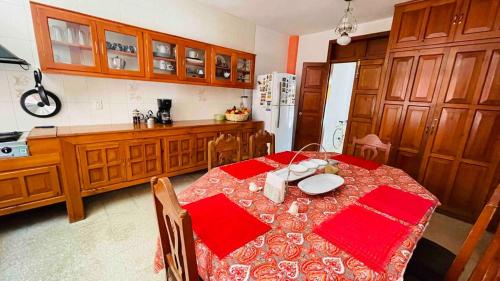 a kitchen with a table with red napkins on it at Casa Nazimova Indigo Room in San Cristóbal de Las Casas