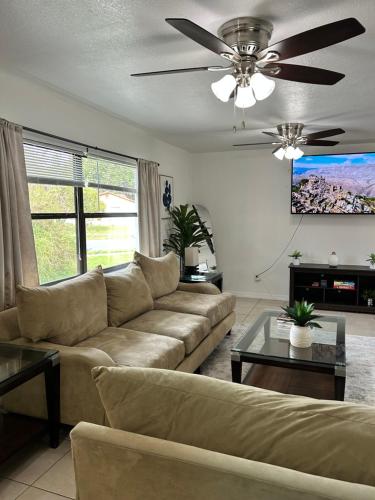 a living room with a couch and a ceiling fan at Peaceful Home in Central Florida Near Universal in Orlando