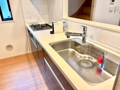 a kitchen with a sink and a stove at Casa Stella 17 by Liaison in Osaka