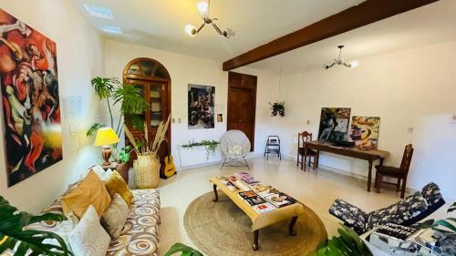a living room with a couch and a table at Casa Nazimova Indigo Room in San Cristóbal de Las Casas
