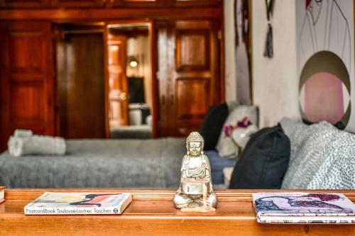 a figurine sitting on a table in a living room at Casa Nazimova Indigo Room in San Cristóbal de Las Casas