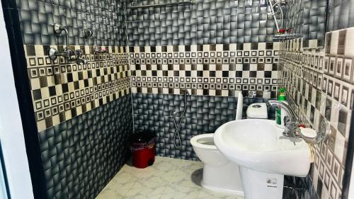 a bathroom with a toilet and a sink at Institute Of Natural Medicine , Yoga & Therapy home in Kathmandu