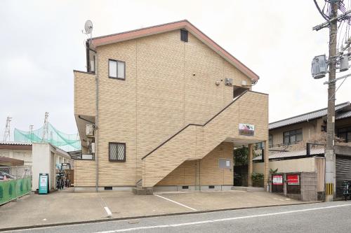 a building with a staircase on the side of it at C Frase Torikai in Muromimachi