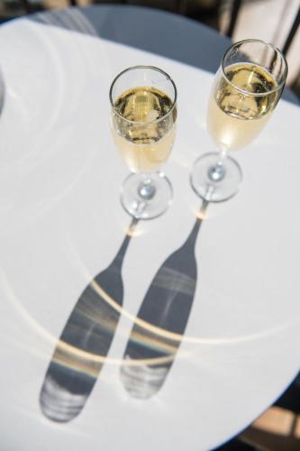 two glasses of wine sitting on a table at Delorenzo Studio Apartments in Nelson