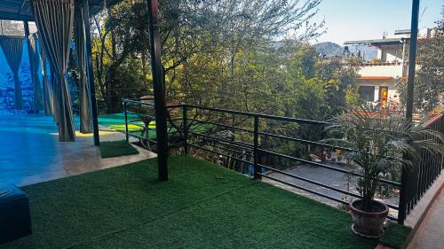a balcony with a view of a swimming pool at Institute Of Natural Medicine , Yoga & Therapy home in Kathmandu