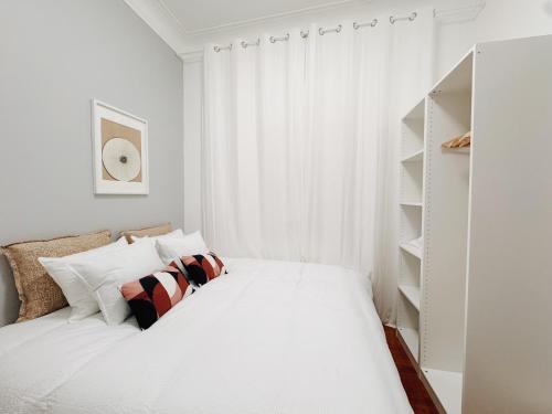 a white bedroom with a bed and a window at Soar Home l Airport l Olivais in Lisbon