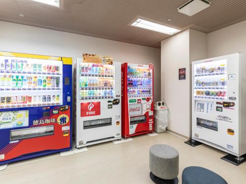 two vending machines in a room with soda at Century Plaza Hotel in Tokushima