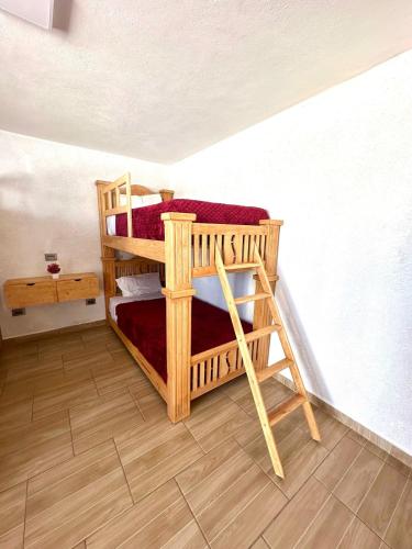 two bunk beds in the corner of a room at Garden and Villas Yami in Coaxuxco
