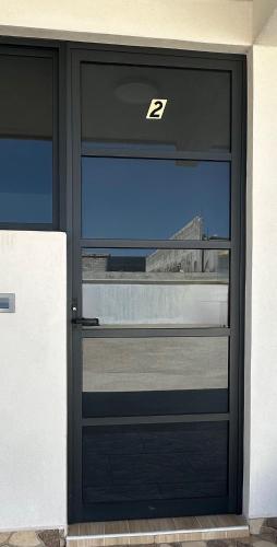 a door with a view of a building through it at Garden and Villas Yami in Coaxuxco