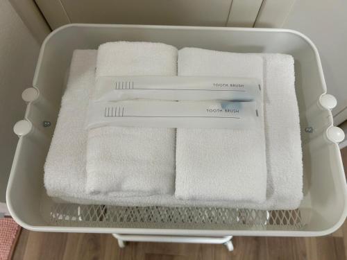 a tray filled with white towels in a refrigerator at SABBATH uzumasa 101 in Kyoto