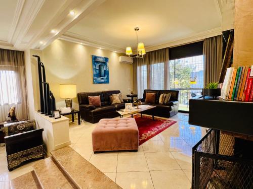 a living room with a couch and a table at Rabat Agdal Pearl - 2BR Spacious & Well located in Rabat