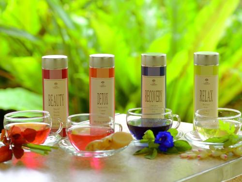 a group of three bottles of alcohol and bowls of food at The Terrace Club Wellness Thalasso At Busena in Nago