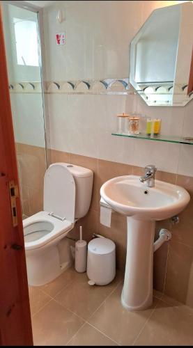 a bathroom with a toilet and a sink at By The Way Apartment 1 in Larnaca