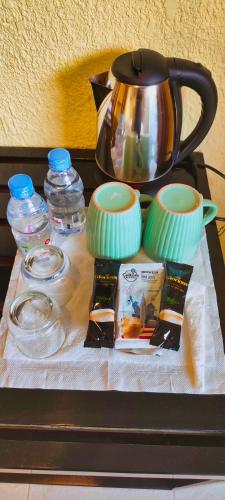 a table with a tea kettle and other items on it at P1 Club Resort in Panglao Island