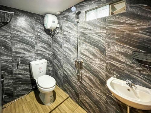 a bathroom with a toilet and a sink at RedDoorz Near Alun Alun Blitar in Karangtengah