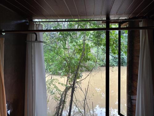 a window in a room with a view of a beach at Harmony by the lake in Dambulla